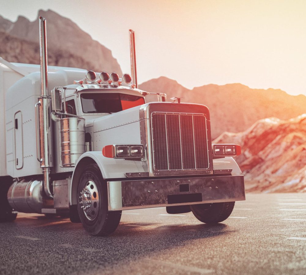 A white truck running on the street in the morning.