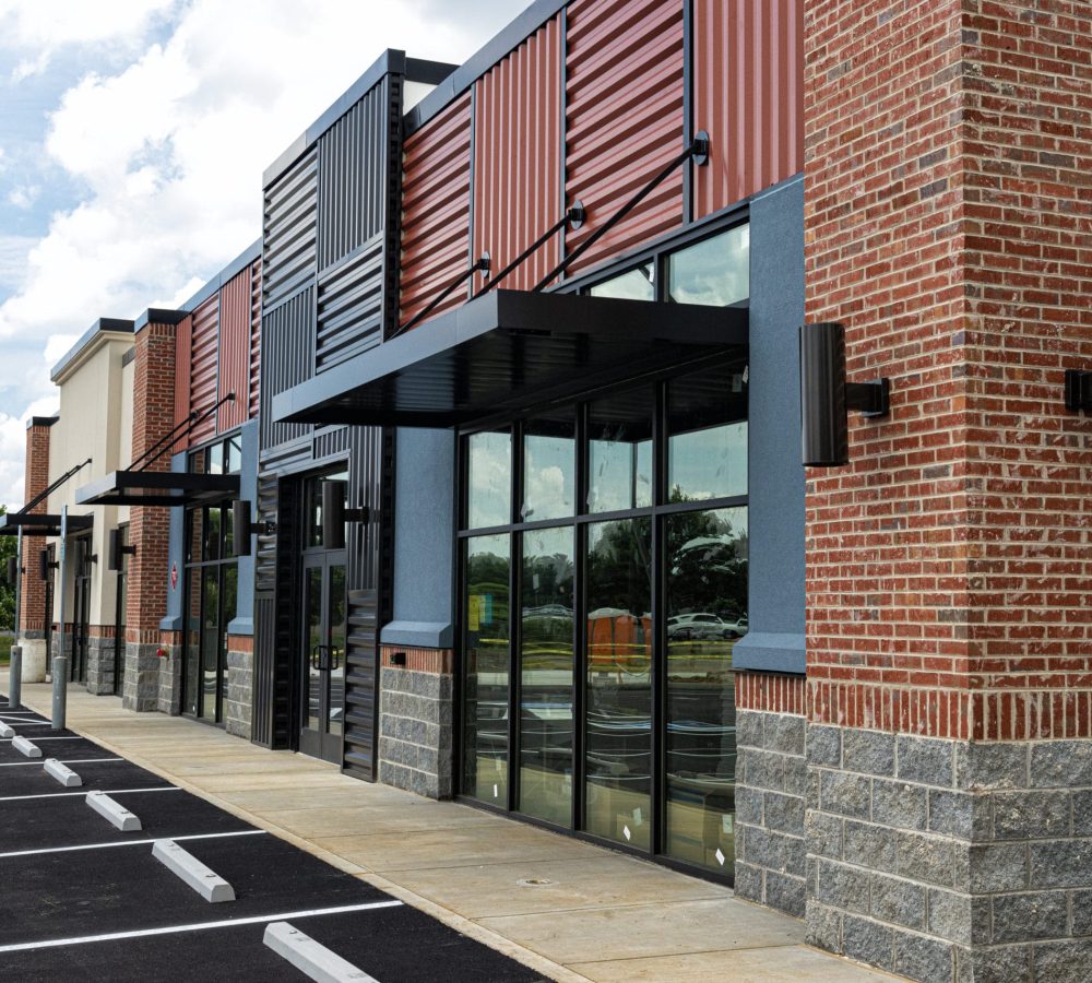 Horizontal shot of a new strip shopping center almost ready to open.